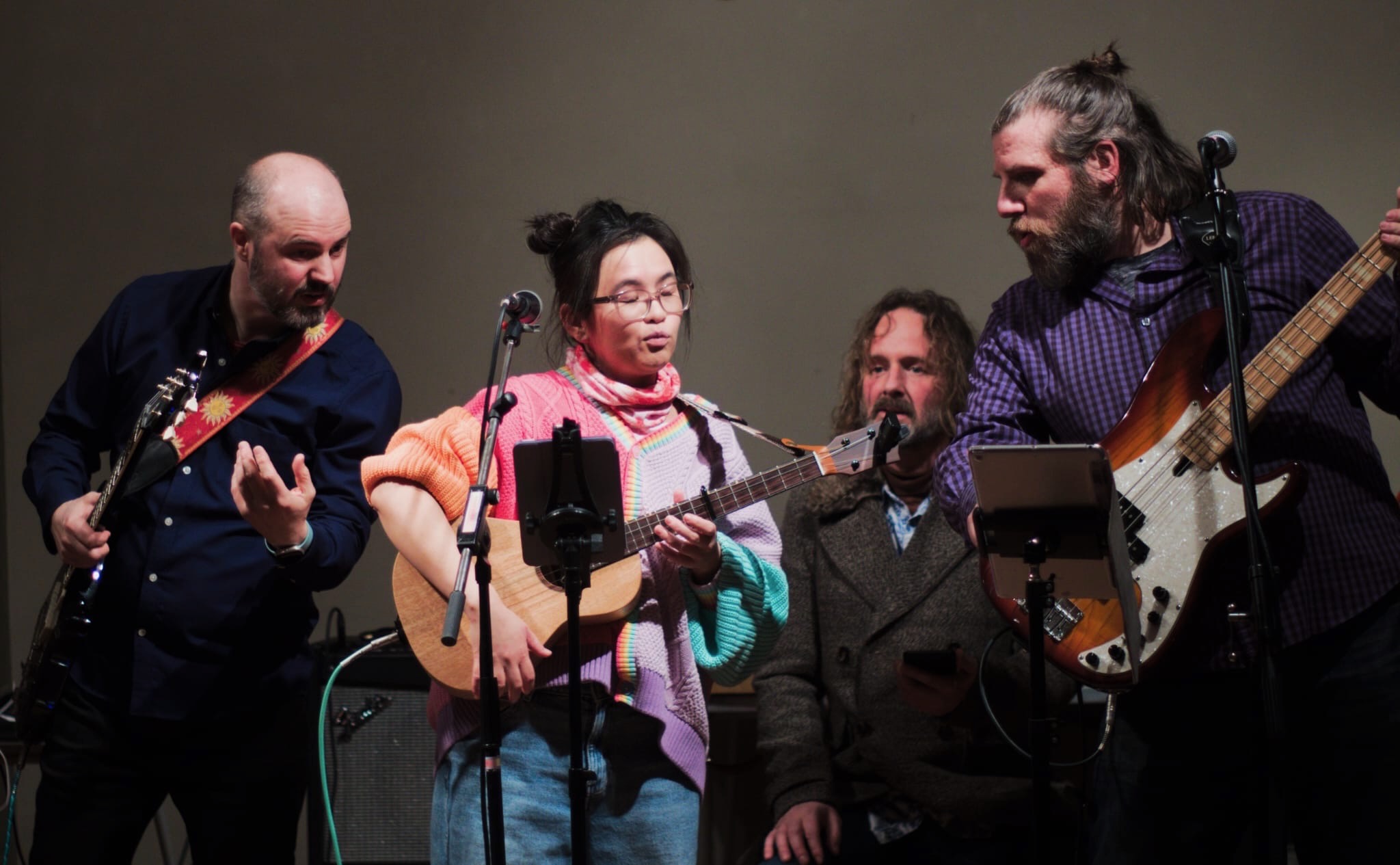 Band on stage all looking at a tablet
